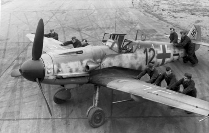 Luftwaffe ground-crew positioning a Bf-109G-6 "Kanonenvogel" equipped with the Rüstsatz VI underwing gondola cannon kit. JG 2, France - September 1943 (Photo Source: German Federal Archives)
