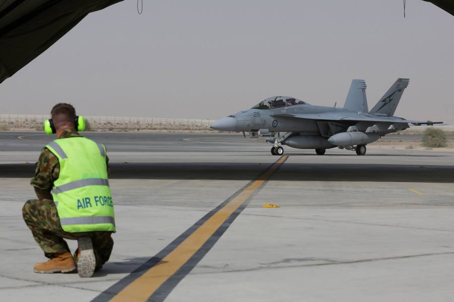 RAAF airman waits to marshal a RAAF F/A-18F Super Hornet after its arrival in the Middle East in October 2014