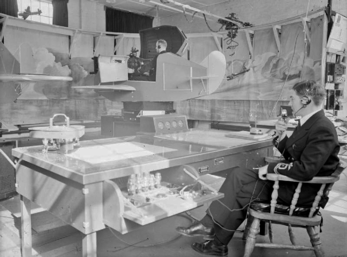 Activities at Royal Naval Air Station Lee-on-solent, 13 To 17 September 1943 The Link trainer in action at the RNAS Lee-on-Solent. Here budding pilots receive their first training in blind flying while the instructing officer speaks to them by phone.