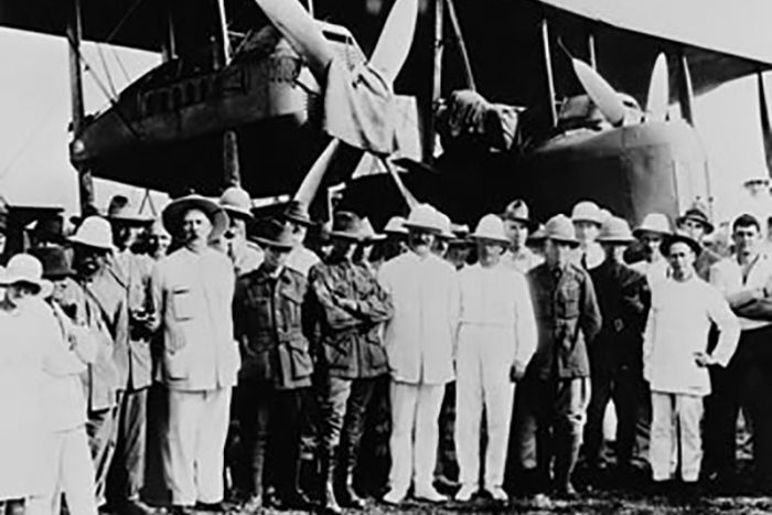 Ross and Keith Smith, left of center, wearing khakis and slouch hats, on their arrival at Darwin, Northern Territory - December 10th, 1919