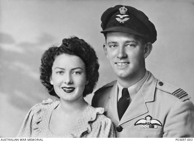 Studio portrait of Flight Lieutenant Bruce Edward "Buster" Brown DFC and Bar RAAF and his girlfriend Polly, whom the P-40E Kittyhawk he flew at Milne Bay, New Guinea was named after - Photo taken Circa 1940 (Photo Source: AWM P03697.002)